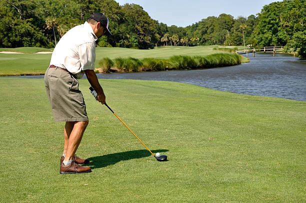 man golfing on Hilton Head Island Man golfing on a beautiful golf course at Sea Pines Resort on Hilton Head Island in South Carolina. hilton head photos stock pictures, royalty-free photos & images