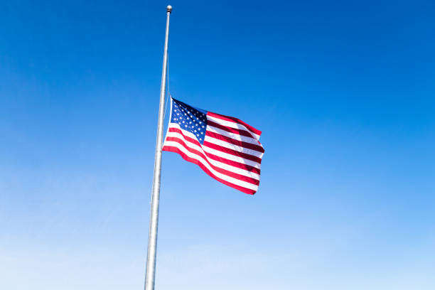 Half mast American flag stock photo
