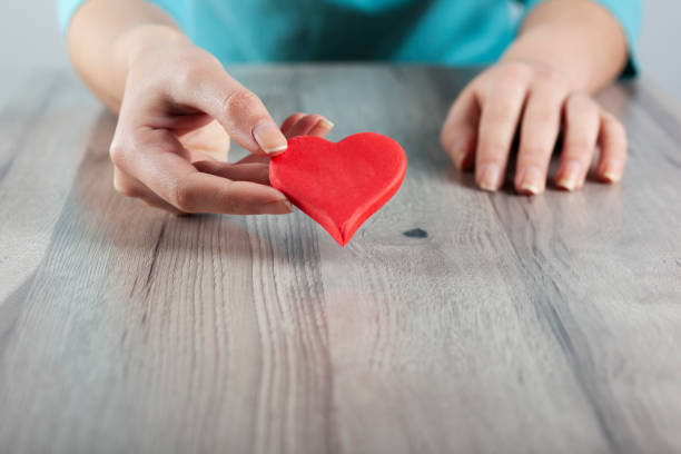istock woman hand red heart 1221672023