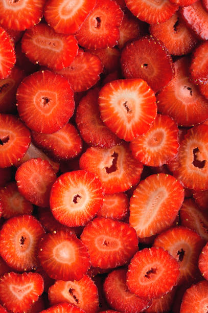 istock Sliced strawberry background and texture. Vertical photo. 1221672713
