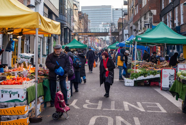People shopping in the market in Surrey Street in Croydon, Surrey, a suburb in South London, on a cold winter’s day. Surrey Street Market is one of the oldest markets in the UK, dating from the 13th century.