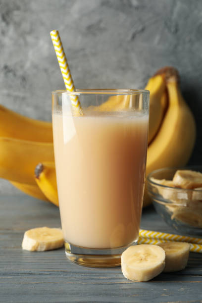 istock Bananas and juice against gray background. Fresh fruit 1221674015