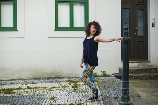 Young mixed-race female model on the streets of Porto, Portugal.