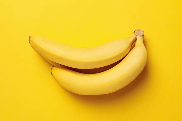 istock Banana cluster on yellow background. Fresh fruit 1221675782