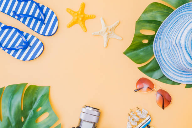 istock Flat lay composition with a summer hat and flip flops on a yellow background 1221676803