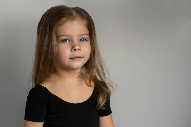 portrait of a beautiful little girl 3-4 years old. copy space to the right - child caucasian little girls 3 4 years imagens e fotografias de stock