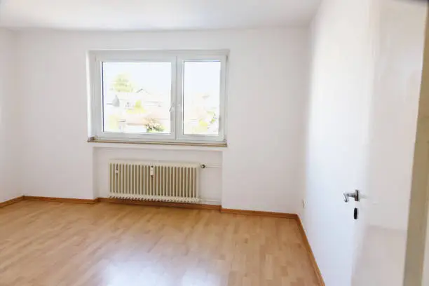 Living room, unfurnished with wooden flooring, no people