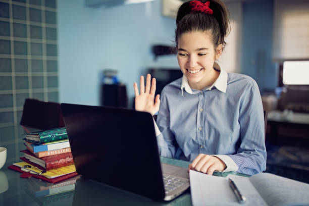 istock Young girl is e-learning and video conferencing at home 1221677479