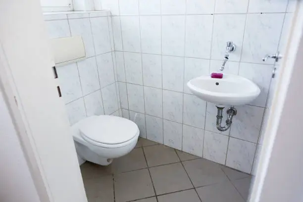 Small room for a toilet and a small sink for hand washing