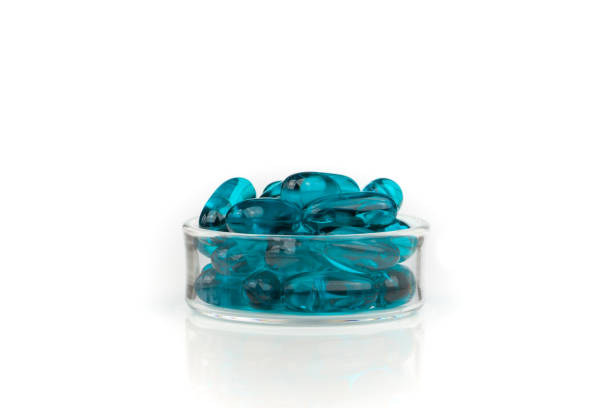 istock Blue medical gel capsules on white background 1221678059