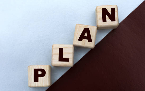 istock PLAN , the word is written on cubes on a gray brown background 1221679712