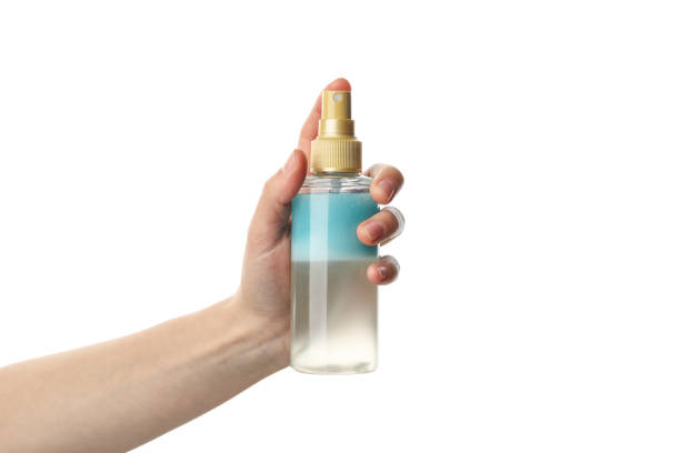istock Female hand holds cosmetic spray, isolated on white background 1221679810