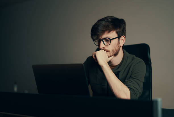 istock Young man working on computer at his workplace. Young business man working from home. 1221681074