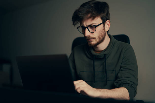 istock Young man working on computer at his workplace. Young business man working from home. 1221681099