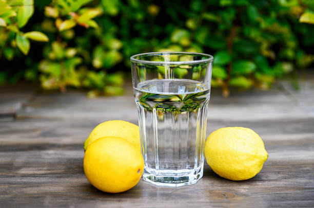 istock Squeezing a lemon into the water. Cooking lemon water. 1221682063