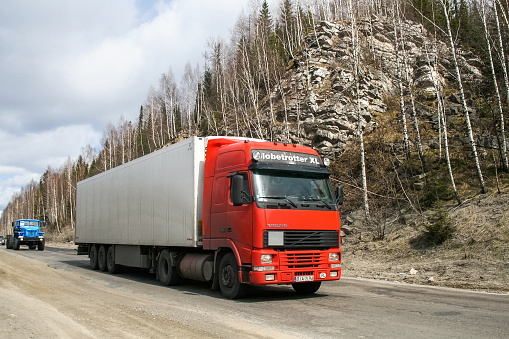 Chelyabinsk Region, Russia - April 27, 2008: Red semitrailer truck Volvo FH12.420 at the interurban road.