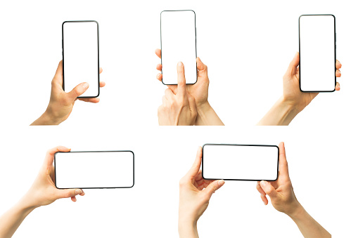 Hand holds mobile phones with white screens. Blank mockups of smartphones isolated. Empty cellphone frame.