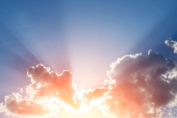 istock Sunset rays behind the clouds and shadows on blue sky, copy space. 1221684639