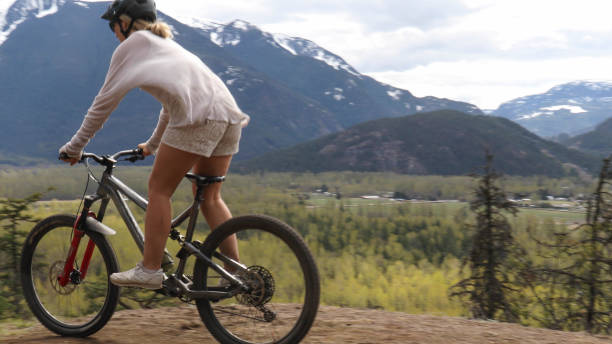 istock Female mountain biker rides along mountain ridge 1221685027
