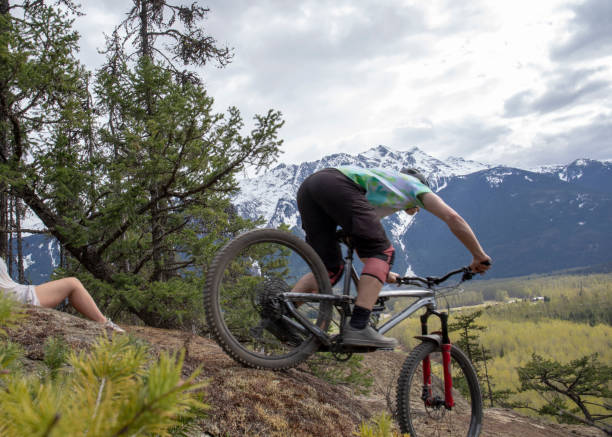 istock Mountain biker rides along mountain ridge 1221685110