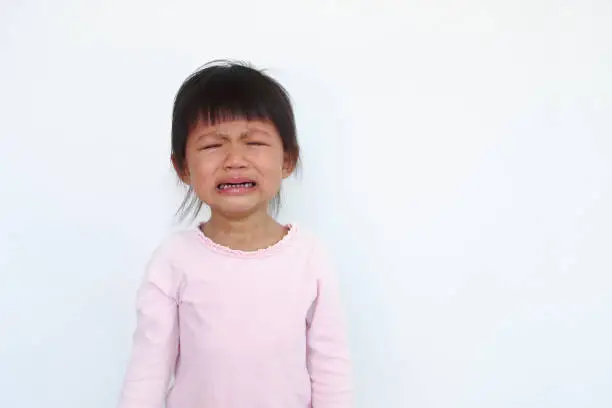 Photo of one naughty asian kid is crying