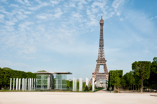 Eiffel Tower and Champ de Mars are empty during pandemic Covid 19 in Europe. There are no people, no tourists because people must stay at home and be confine. Schools, restaurants, stores, museums... are closed. In the foreground, there is the \