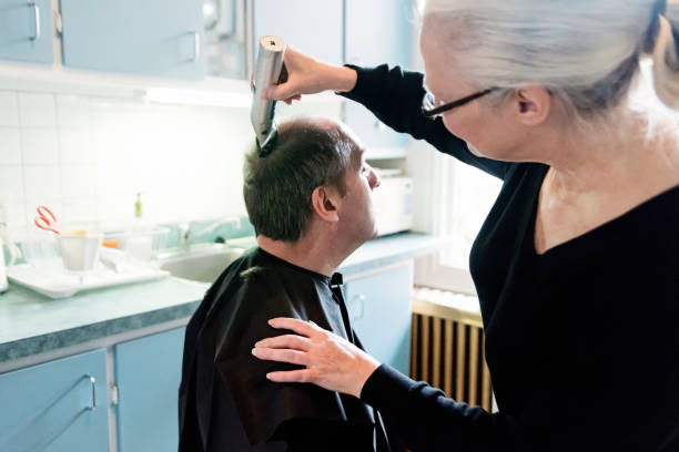 istock Home haircut for mature couple. 1221689861