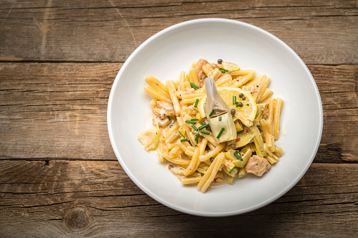 Photograph of fresh lemon pasta with artichoke hearts and chicken.