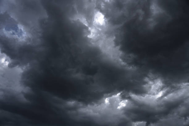 istock Terrible thunderclouds from the side of a plane. Gloomy epic clouds. Background image in a dark gray style. 1221692521