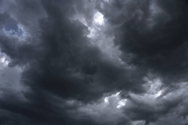 Terrible thunderclouds from the side of a plane. Gloomy epic clouds. Background image in a dark gray style. stock photo
