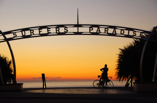 Welcome sign in the heart of Surfers Paradise, the holiday capital of the Gold Coast, Queensland Australia with beach in background.