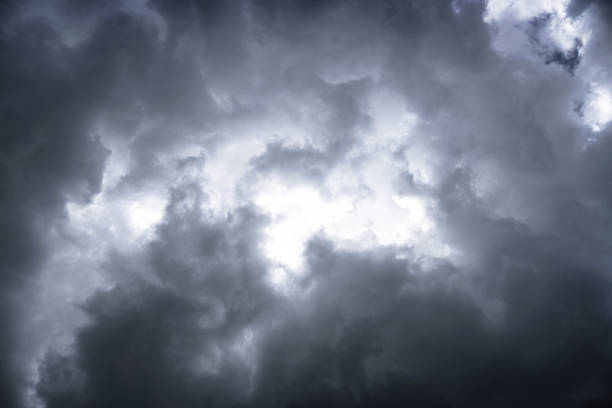 istock Terrible thunderclouds from the side of a plane. Gloomy epic clouds. Background image in a dark gray style. 1221692756