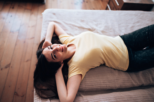 woman lying down happiness on the bed