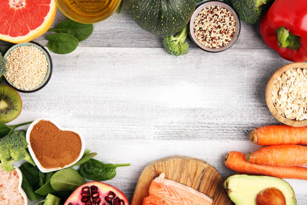 istock Healthy food clean eating selection: fish, fruit, vegetable, cereal, leaf vegetable on rustic background 1221693615