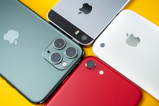 Paris, France - Apr 26, 2020:Four smartphones 11 pro, 2016 SE, 3gs next to new budget iPhone SE by Apple Computers touch ID, Single-lens rear camera and iPhone 8 design
