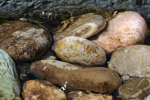 Round stones lie in water