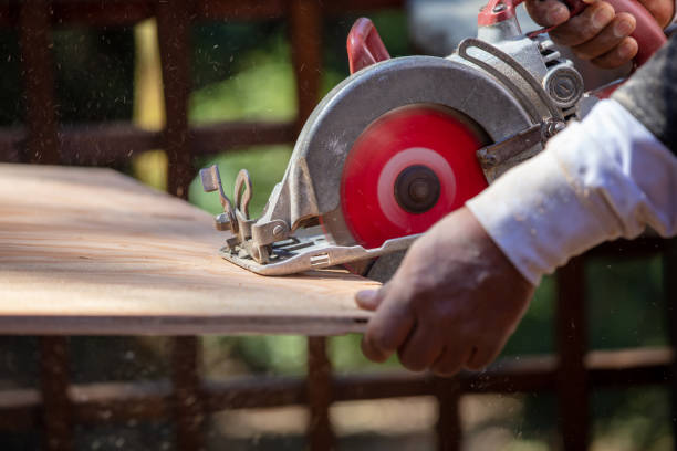 istock Man sawing wood with electric circular saw. 1221696333