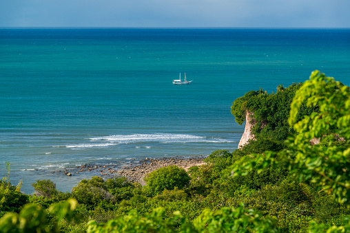Sailboat on Pipa beach, Tibau do Sul, near Natal, Rio Grande do Norte, Brazil on June 7, 2019. With its cliffs and natural vegetation, this beach attracts tourists from all over the world