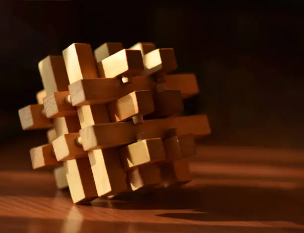 Wooden game block puzzle abstract close up on dark background