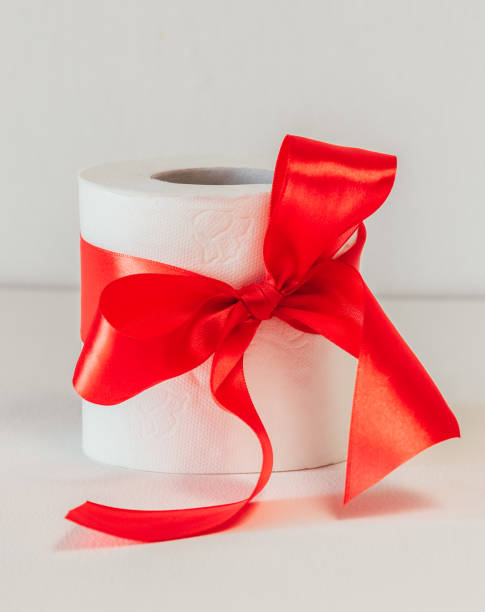 istock white toilet paper with a red bow on a white background. 1221697471