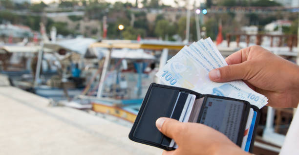Traveling in the harbor - Turkish Lira banknote wallet stock photo