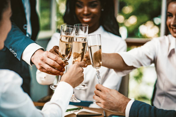 toast de célébration à l’événement d’affaires de l’équipe diverse - champagne flute champagne black wineglass photos et images de collection