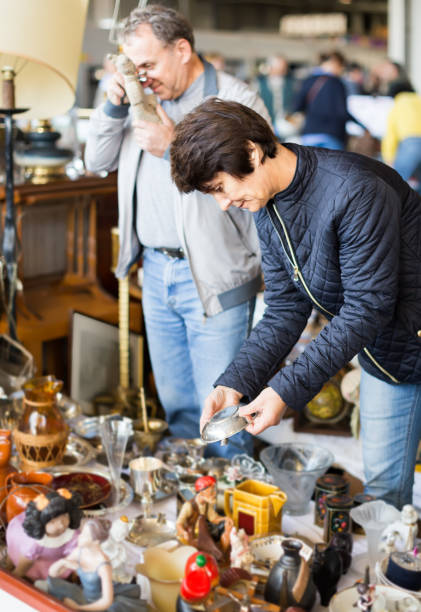 istock concentrated elderly woman choosing interesting souvenirs at flea market 1221701861