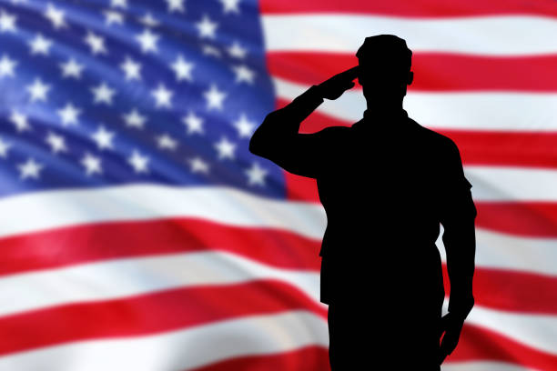 soldiers silhouette saluting the usa flag for memorial day or veterans day - saluting imagens e fotografias de stock