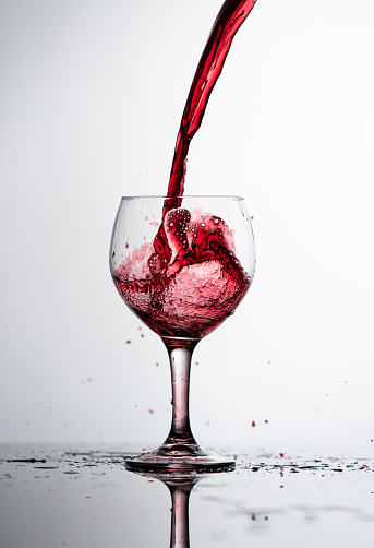 Red Wine Glass spilling and splashing.