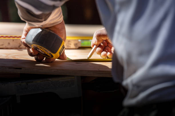 istock Carpenter measuring with triangle on wood for cutting 1221708094