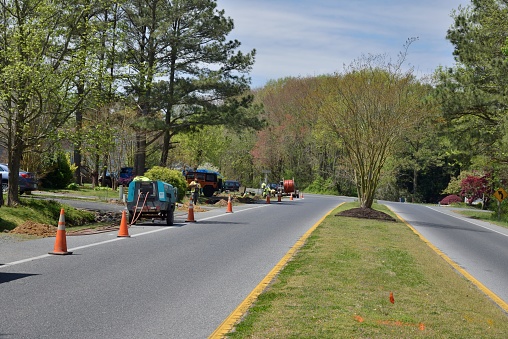 A construction team that appears to be Hispanic install fiber optic cables in Ocean Pine, Maryland enjoying still being employed during the COVID-19 restrictions impose by the Governor of Maryland
