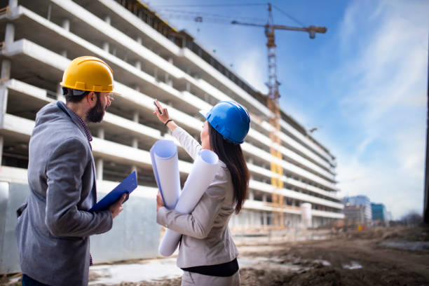 istock Multi-ethnic engineer workers with blueprint on the construction site stock photo 1221710296