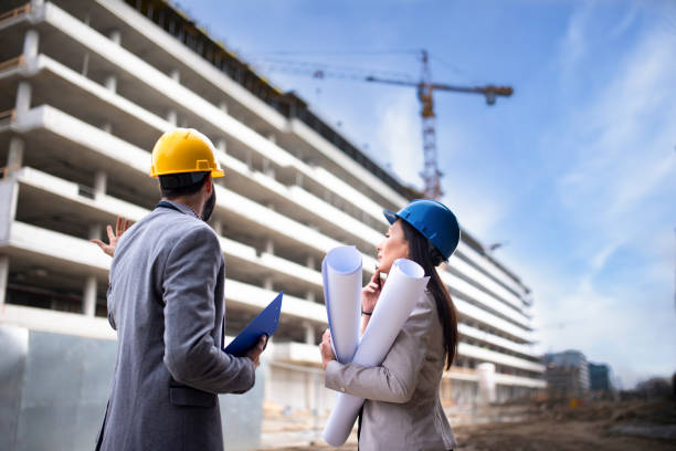 istock Multi-ethnic engineer workers with blueprint on the construction site stock photo 1221710888