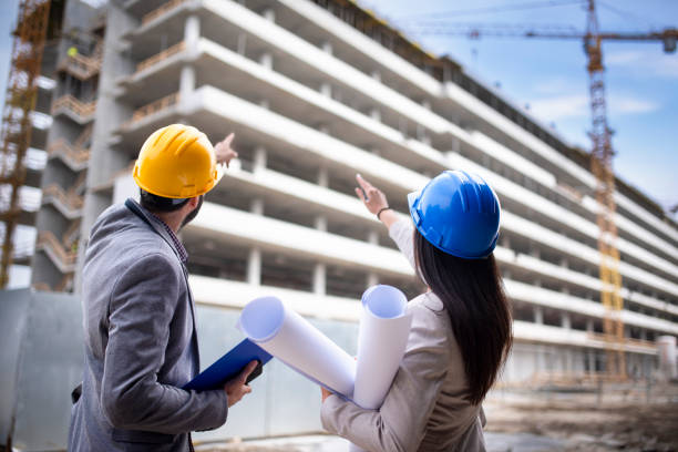 istock Multi-ethnic engineer workers with blueprint on the construction site stock photo 1221711061